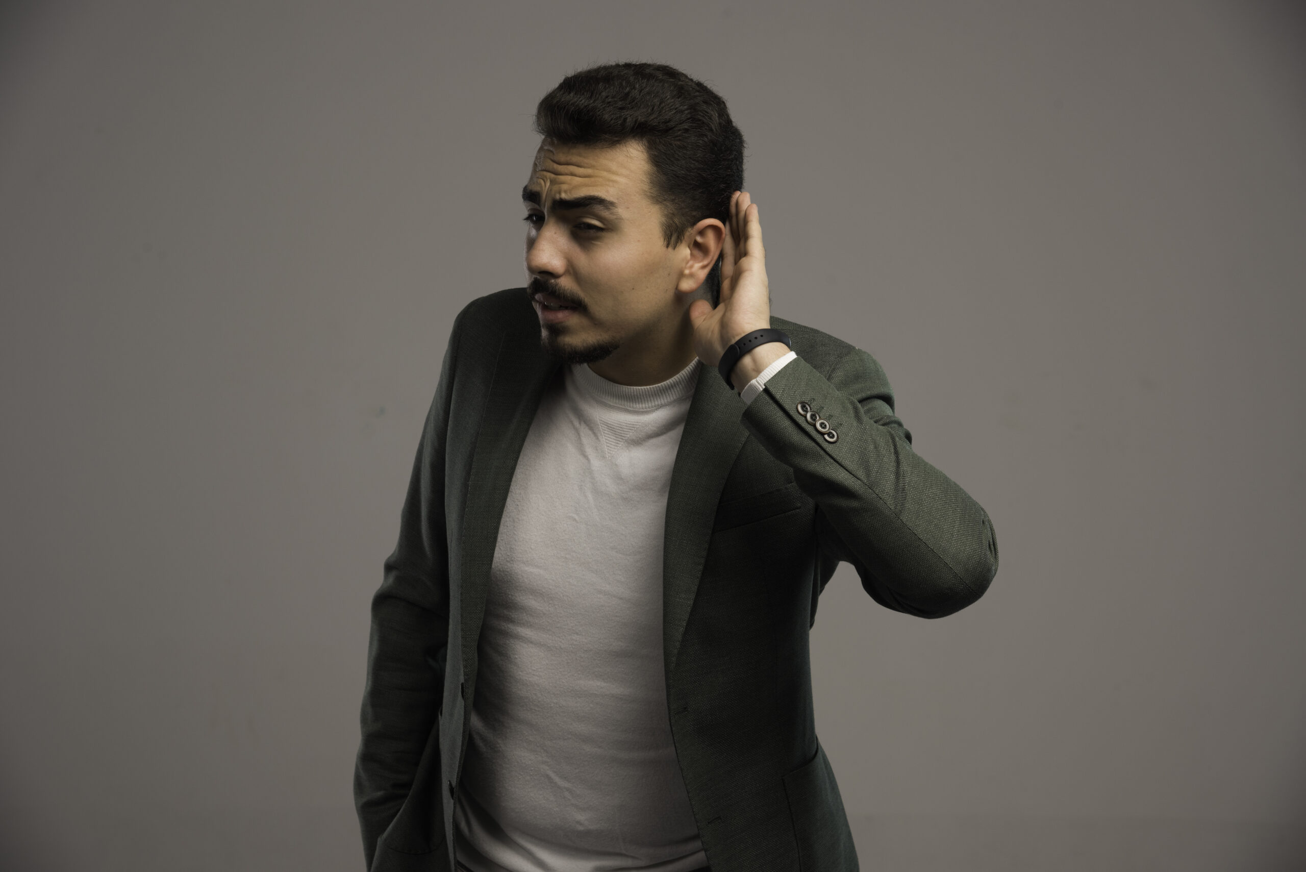 A businessman in dress code can not hear anything. High quality photo